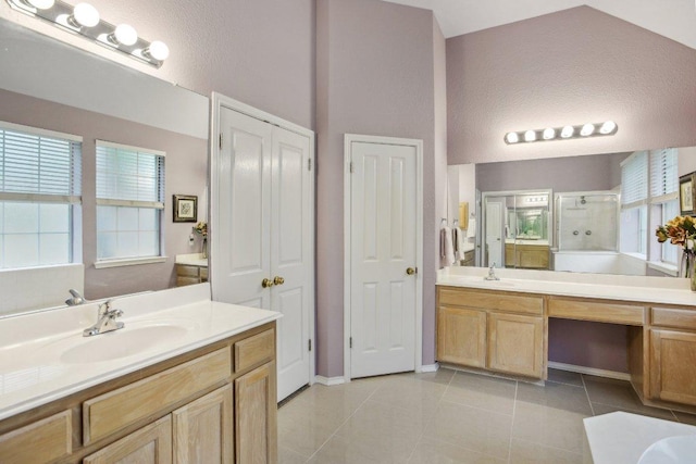 full bath featuring a sink, tile patterned floors, two vanities, and a shower stall