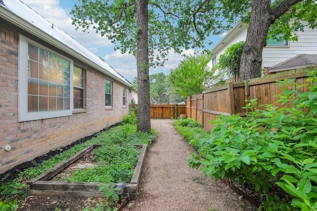 view of yard featuring a garden and a fenced backyard