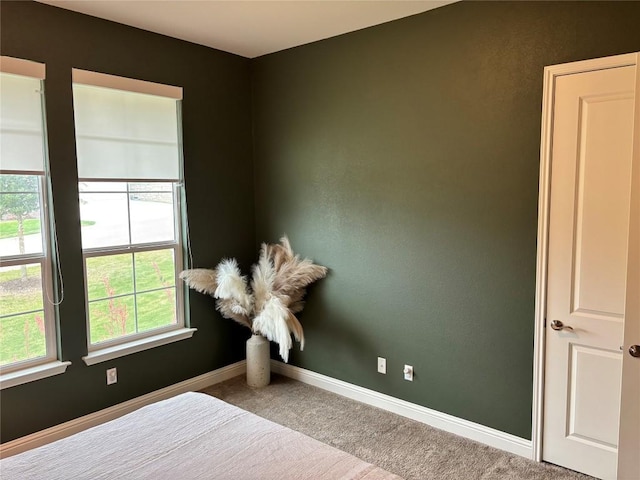 bedroom featuring carpet floors and baseboards