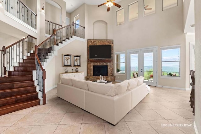 8293 Lime Creek Rd, Leander, TX 78641 - tiled living area featuring a high ceiling, a ceiling fan, stairs, baseboards, and french doors