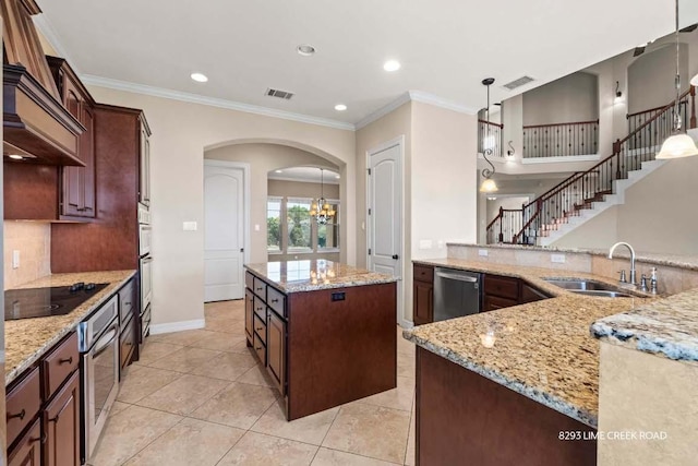 kitchen with arched walkways, visible vents, black electric stovetop, and a sink
