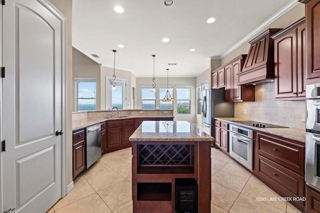 kitchen with backsplash, crown molding, appliances with stainless steel finishes, and a sink