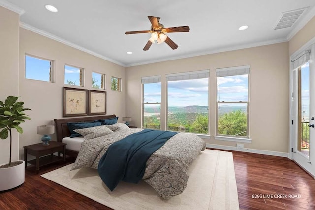 bedroom with visible vents, recessed lighting, crown molding, and wood finished floors