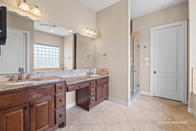 8293 Lime Creek Rd, Leander, TX 78641 - full bath with a ceiling fan, a stall shower, double vanity, tile patterned flooring, and baseboards