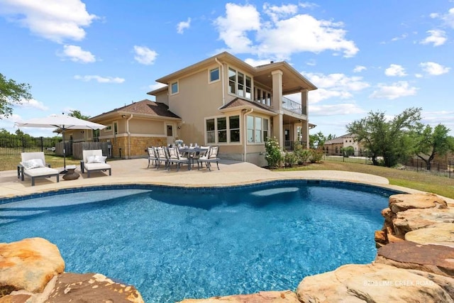 view of pool featuring fence, a fenced in pool, and a patio