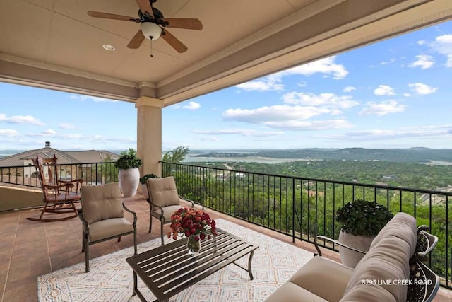 balcony featuring an outdoor living space and a ceiling fan