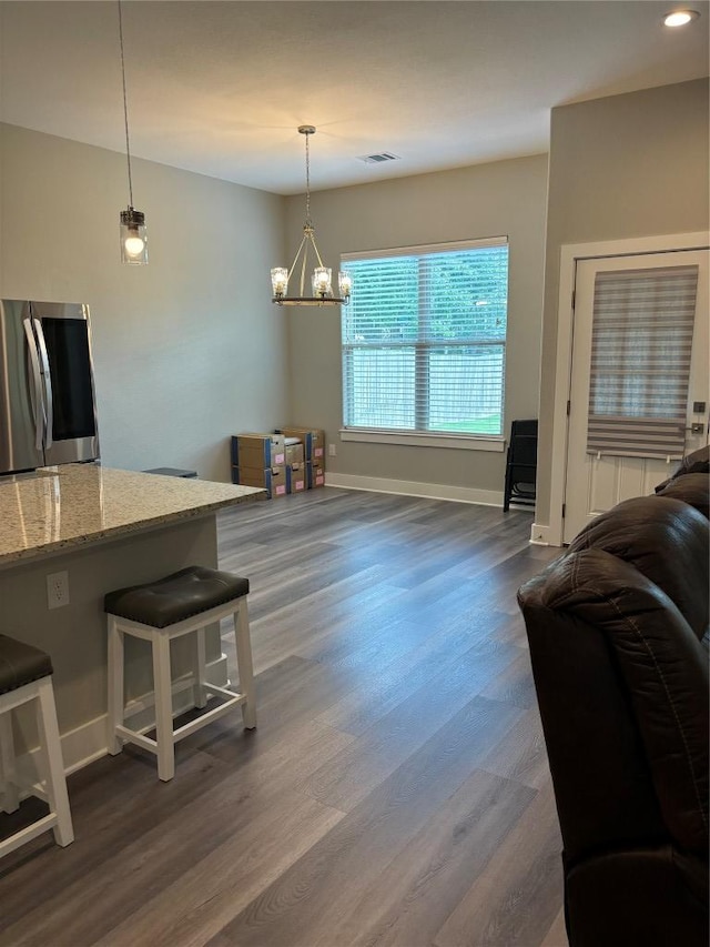 170 Nuuanu Rd, Bastrop, TX 78602 - living area featuring dark wood-style flooring, baseboards, and a chandelier