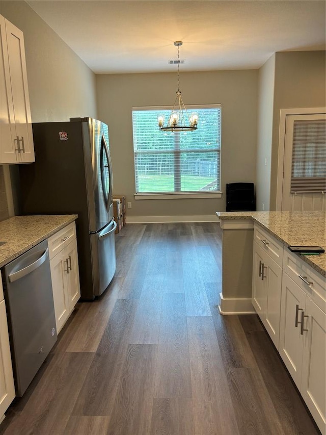 170 Nuuanu Rd, Bastrop, TX 78602 - kitchen featuring appliances with stainless steel finishes, dark wood-style flooring, white cabinetry, and light stone countertops