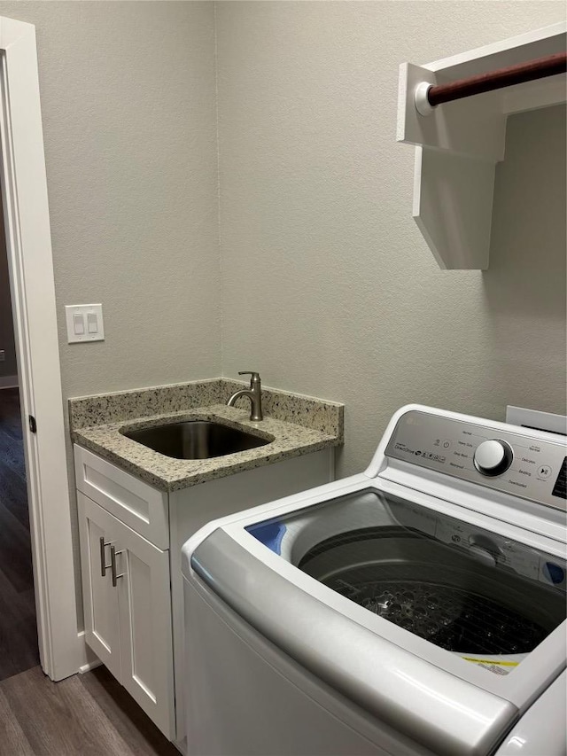 170 Nuuanu Rd, Bastrop, TX 78602 - laundry area with dark wood-type flooring, cabinet space, and washer and clothes dryer