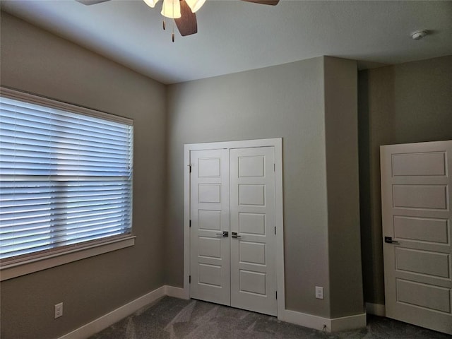 170 Nuuanu Rd, Bastrop, TX 78602 - unfurnished bedroom with dark colored carpet, baseboards, a closet, and ceiling fan