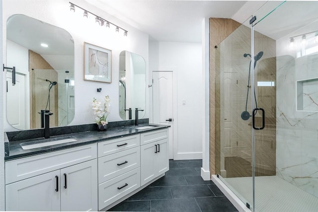 3838 Laurel Ridge Dr, Round Rock, TX 78665 - bathroom featuring double vanity, a stall shower, tile patterned flooring, and baseboards