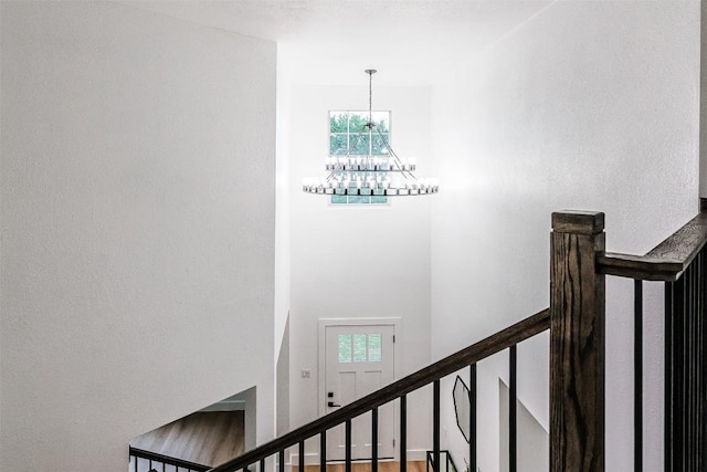 stairway featuring a chandelier and healthy amount of natural light