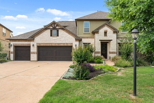 503 Wester Ross Ln, Lakeway, TX 78738 - french country style house with stone siding, stucco siding, a front lawn, roof with shingles, and driveway