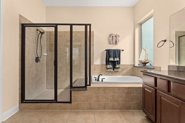 full bathroom featuring tile patterned flooring, vanity, a bath, and a shower stall