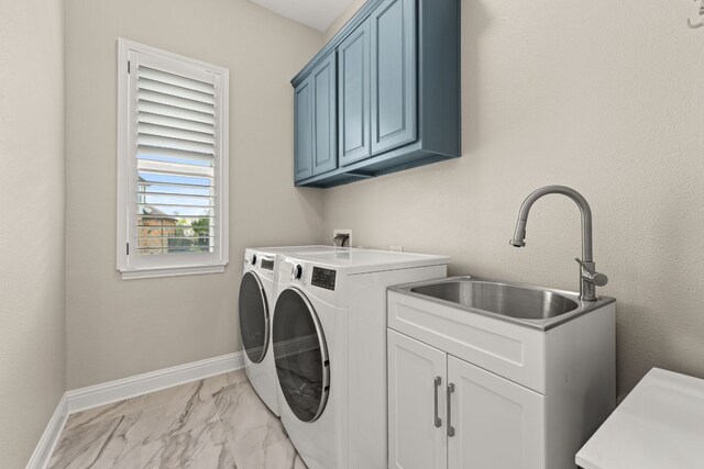 laundry area with cabinet space, a sink, marble finish floor, baseboards, and washer and clothes dryer