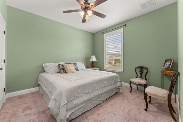 carpeted bedroom featuring visible vents, baseboards, and ceiling fan
