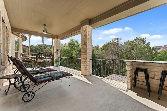 view of patio featuring a balcony and outdoor dining space