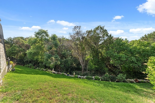 view of yard with fence and a forest view
