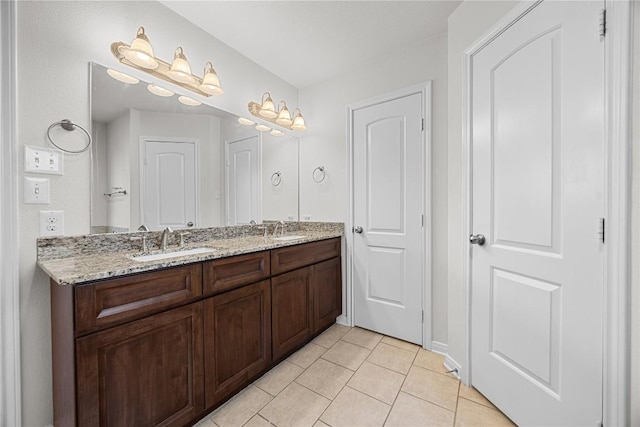bathroom with tile patterned flooring, a sink, and double vanity