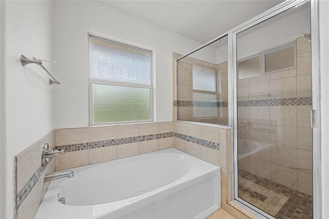 full bathroom featuring a garden tub and a stall shower