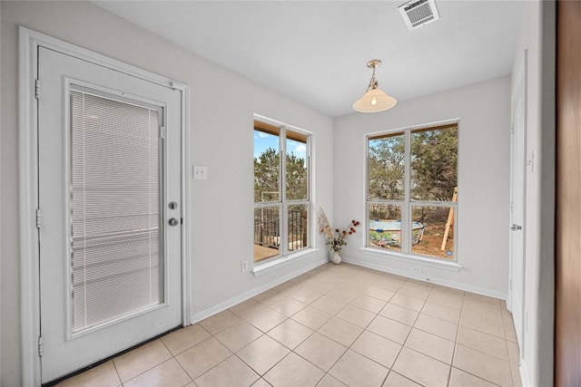 unfurnished dining area featuring visible vents, baseboards, and light tile patterned floors