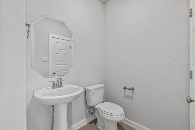 2705 Sage Ranch Dr Unit 25, Leander, TX 78641 - bathroom featuring toilet, wood finished floors, and baseboards