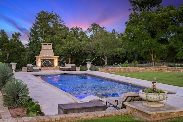 view of swimming pool with a patio, fence, an outdoor living space with a fireplace, and a fenced in pool