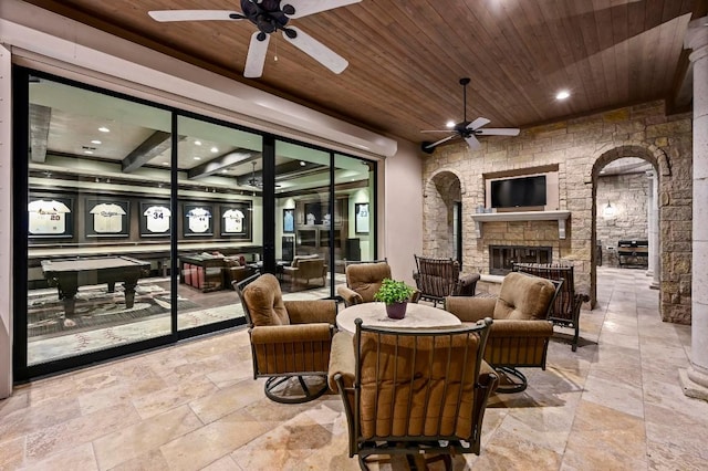 view of patio / terrace featuring a ceiling fan and an outdoor living space with a fireplace