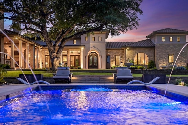 view of swimming pool with french doors