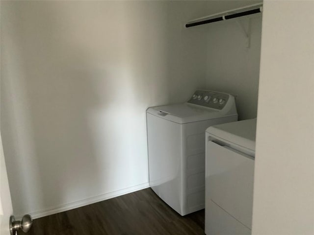 laundry room featuring baseboards, laundry area, dark wood-style floors, and washer and dryer
