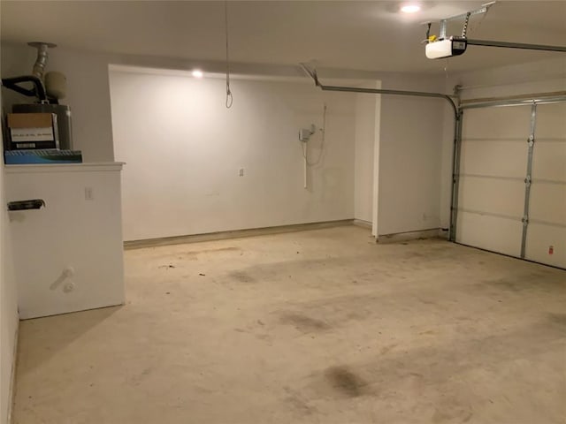 garage with water heater and a garage door opener