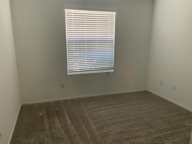 empty room with carpet flooring and baseboards