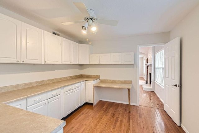 4318 Clarno Dr, Austin, TX 78749 - kitchen featuring white cabinetry, light wood-style floors, a ceiling fan, and light countertops