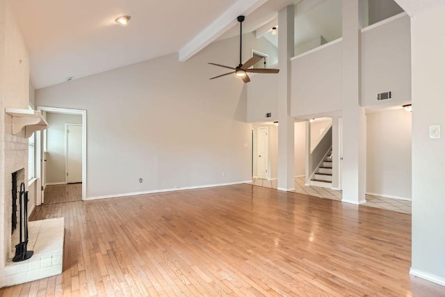 4318 Clarno Dr, Austin, TX 78749 - unfurnished living room featuring a fireplace, ceiling fan, high vaulted ceiling, light wood-style floors, and beam ceiling