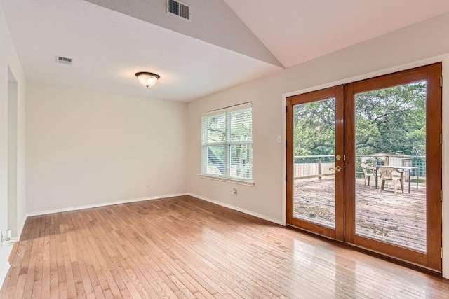 4318 Clarno Dr, Austin, TX 78749 - spare room featuring light wood-type flooring, vaulted ceiling, baseboards, and french doors