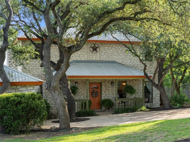 6407 Poncha Pass, Austin, TX 78749 - view of front facade with stone siding, a porch, and metal roof