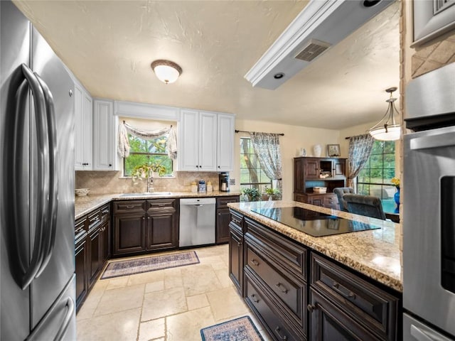 6407 Poncha Pass, Austin, TX 78749 - kitchen featuring stainless steel appliances, white cabinetry, a sink, and dark brown cabinets