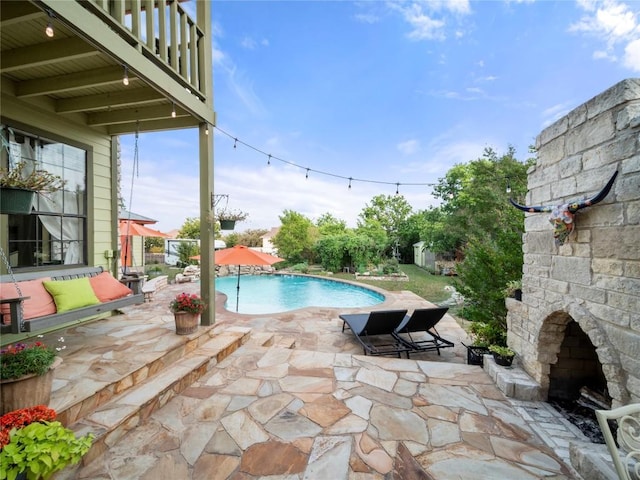 6407 Poncha Pass, Austin, TX 78749 - swimming pool with a patio and an outdoor stone fireplace
