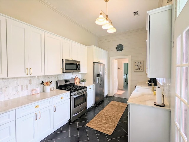 515 E 8th St, Georgetown, TX 78626 - kitchen with ornamental molding, stainless steel appliances, white cabinetry, and visible vents