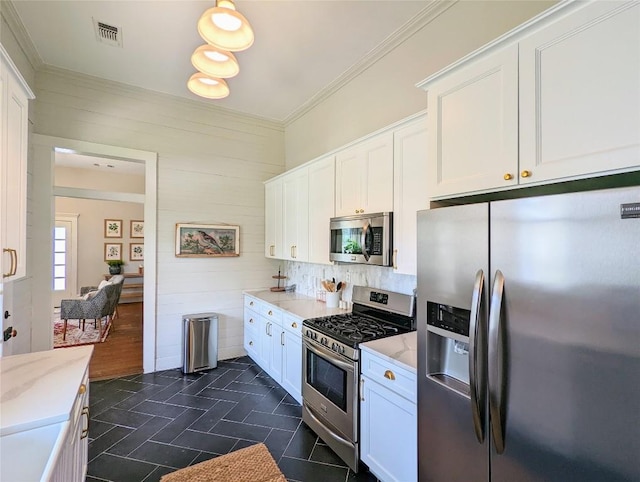 515 E 8th St, Georgetown, TX 78626 - kitchen with visible vents, crown molding, light stone countertops, white cabinetry, and appliances with stainless steel finishes