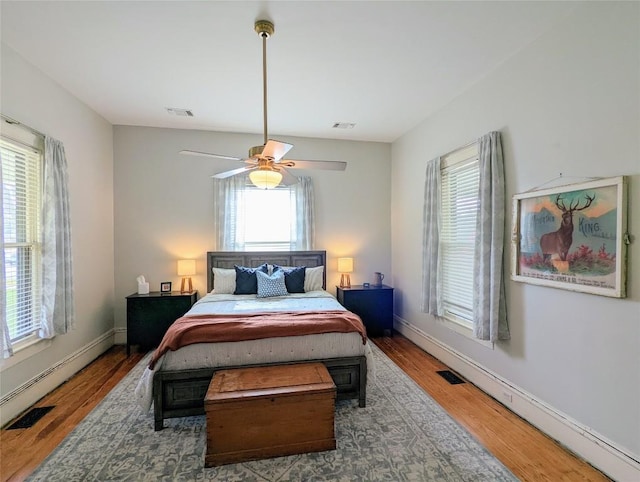 515 E 8th St, Georgetown, TX 78626 - bedroom with multiple windows, wood finished floors, and visible vents