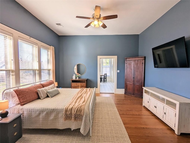 515 E 8th St, Georgetown, TX 78626 - bedroom with visible vents, a ceiling fan, and wood finished floors