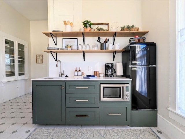 515 E 8th St, Georgetown, TX 78626 - bar featuring a sink, light floors, and stainless steel microwave