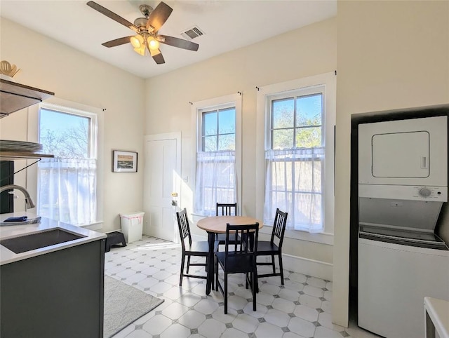 515 E 8th St, Georgetown, TX 78626 - dining space featuring light floors, a wealth of natural light, stacked washer / drying machine, and visible vents