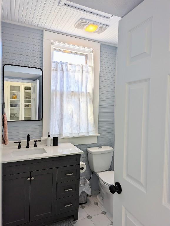 515 E 8th St, Georgetown, TX 78626 - bathroom with vanity, tile patterned floors, visible vents, and toilet