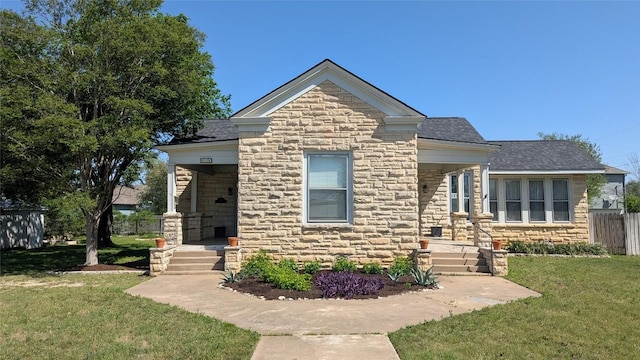 515 E 8th St, Georgetown, TX 78626 - bungalow featuring a shingled roof, a front lawn, fence, and stone siding