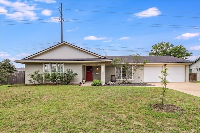 ranch-style home featuring an attached garage, a front lawn, fence, and concrete driveway