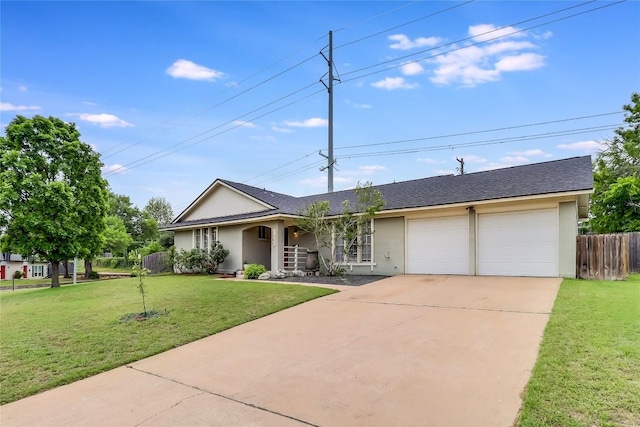 ranch-style home featuring a garage, a front lawn, fence, stucco siding, and concrete driveway