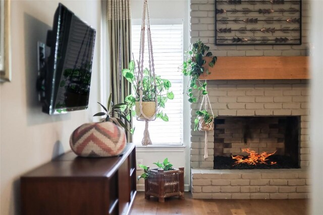 living area with a fireplace and wood finished floors