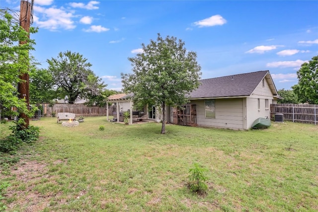 view of yard featuring a fenced backyard and central AC unit